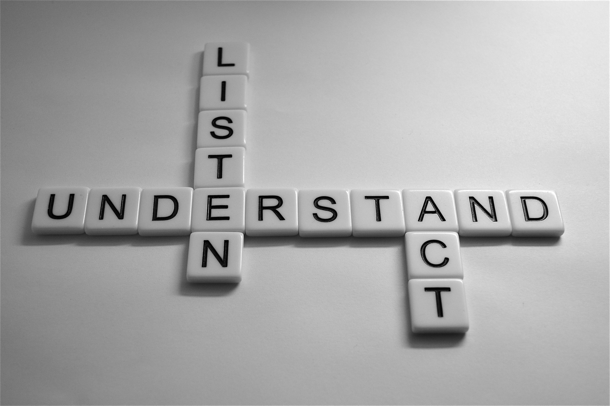 Tiles spell “understand, listen, act.”