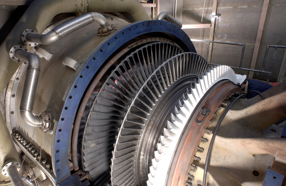 Photograph of a steam turbine connected to a generator.