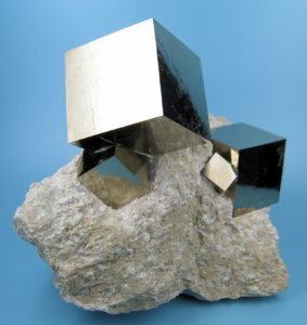 Cubes of pyrite are opaque and silvery in colour