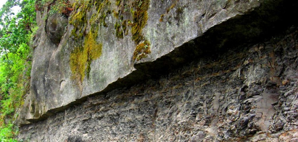 Marine sandstone sticks out over a wall of marine mudstone