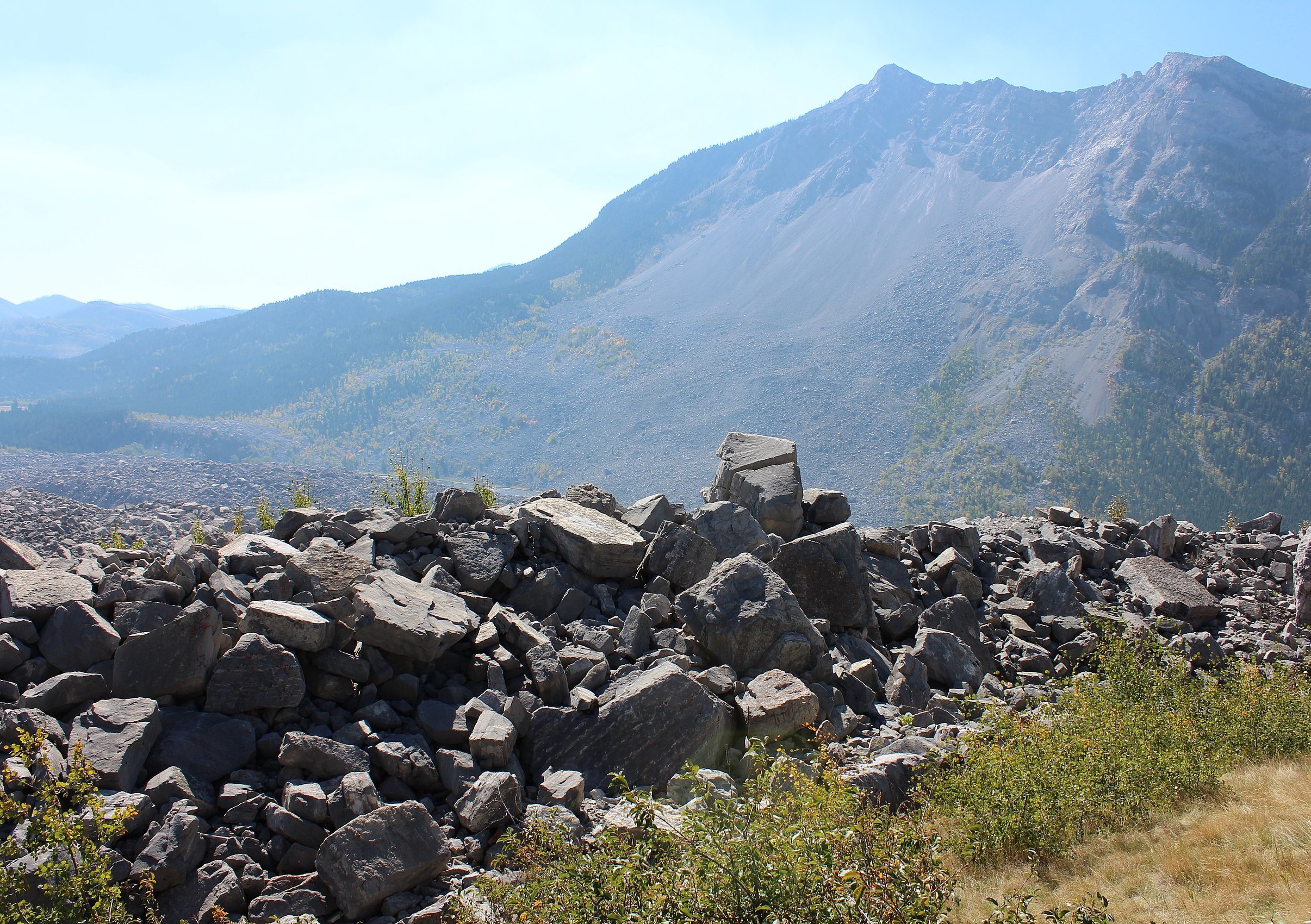 The foreground is filled with rubble. In the background a mountain is visible.