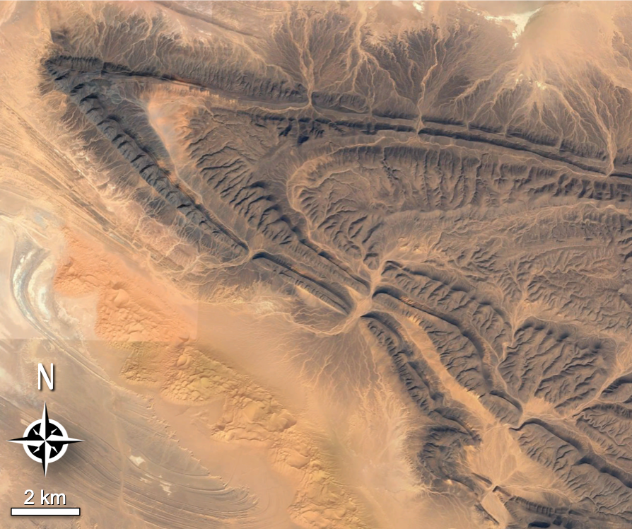 A V-shaped structure on the desert floor, viewed from a satellite.