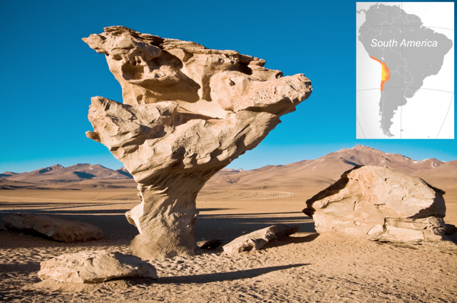 Volcanic rock shaped like a tree in the desert. Insert is the Atacama Desert marked on the west coast of a map of South America.