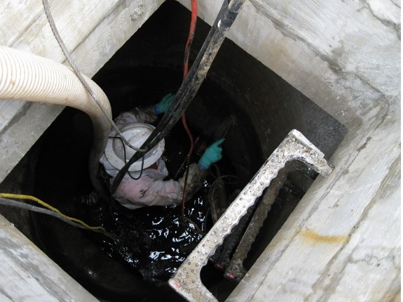 Worker entering a catch basin