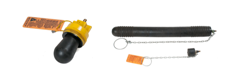 An inflatable test ball (left) and plug (right). The test ball has a bulbous, rounded end and is attached to a threaded top with a connector at the top. The plug is a long cylindrical object with a rounded tip on the bottom and a chain on the top.