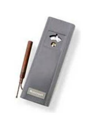 A small grey rectangular box with an interface and a copper pipe attached.