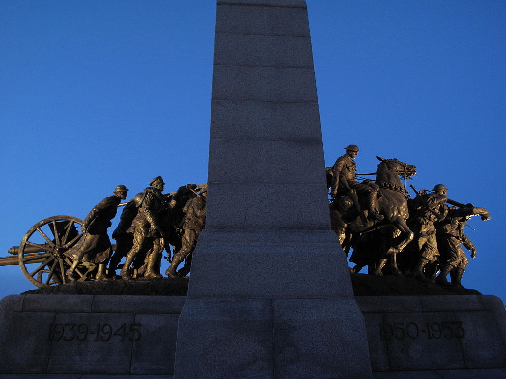 Bronze statue of weary soldiers. One rides a horse. The monument says 1939–1945 and 1950–1953.