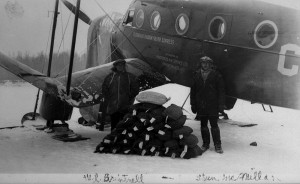 In April 1935 W.L.Britnell and Stan McMillan unload the first load of uranium concentrate from the NWT. The photo is good, but everyone in it was overexposed. (Photo by W.L. Brintnell. Library and Archives Canada / PA-102850() http://collectionscanada.gc.ca/pam_archives/index.php?fuseaction=genitem.displayItem&rec_nbr=3382001&lang=eng