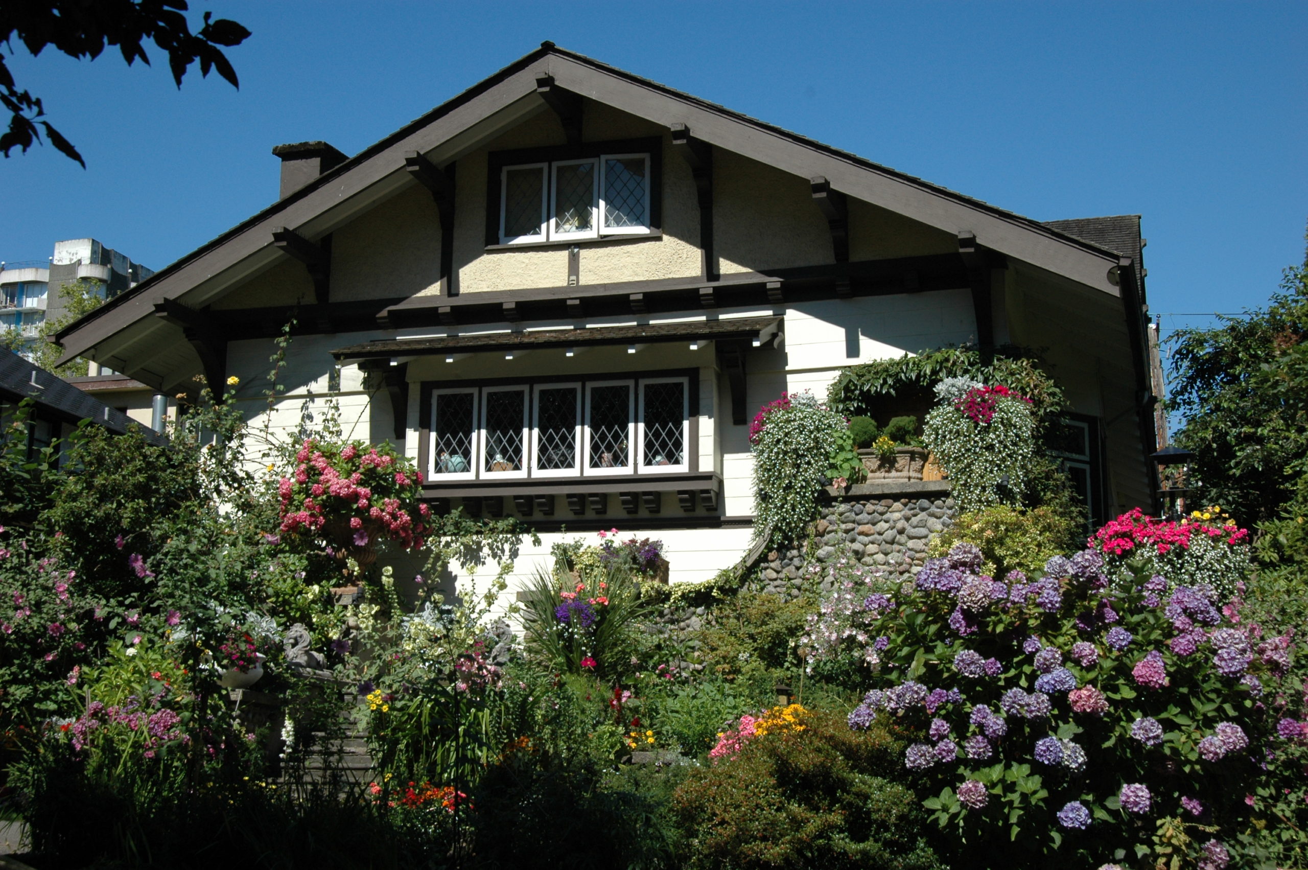 Tudor-style house with a flower garden.