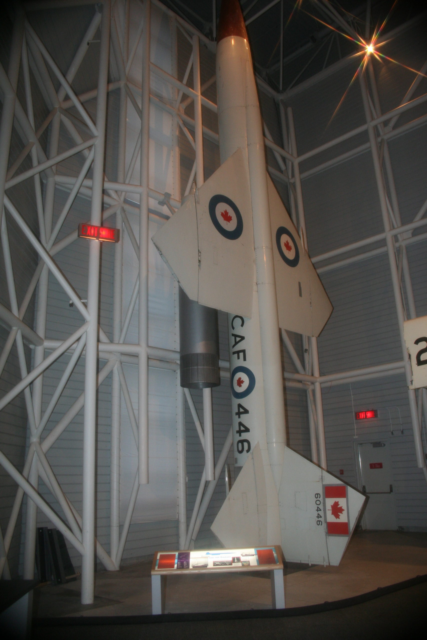 A missile with maple leaves surrounded by blue rings stands upright.