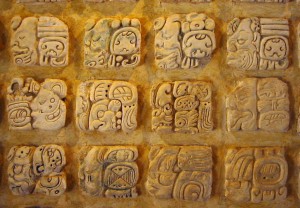 Three rows of square pictures carved into stucco.