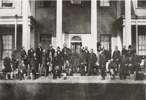 A large group of men wearing suits pose for a picture.