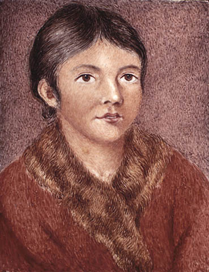 Portrait of a woman with short black hair, wearing a fur coat.