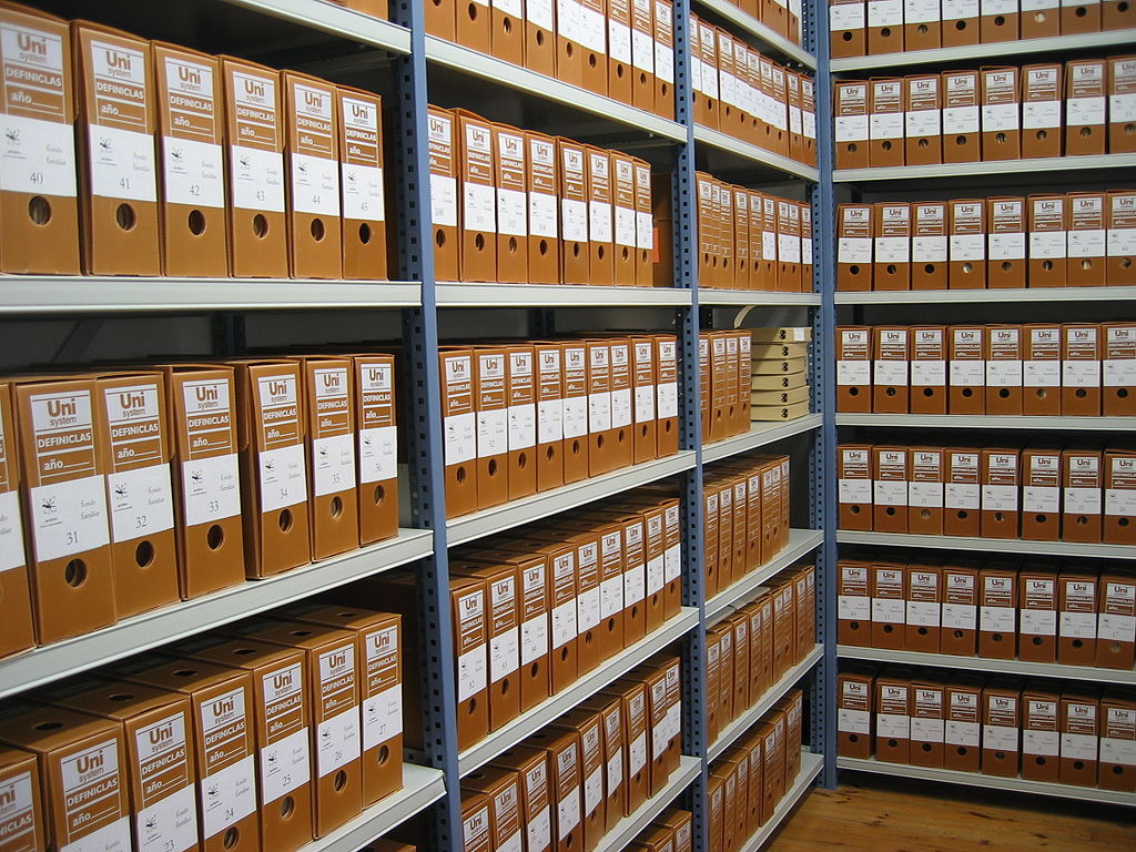 Shelves of archival boxes, neatly labelled and ordered.