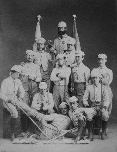 Men pose for a picture in their lacrosse uniforms.