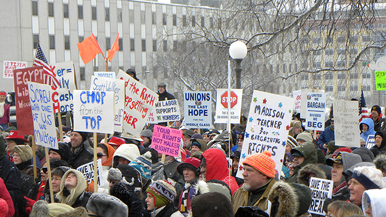 This photograph shows people protesting in response to Wisconsin governor Scott Walker’s collective bargaining laws.