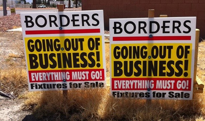 This image is a photograph of a “Going Out of Business” signs for Borders. The signs denote that even the fixtures are for sale.