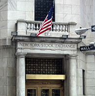 The image is a photograph of the New York Stock Exchange’s entrance