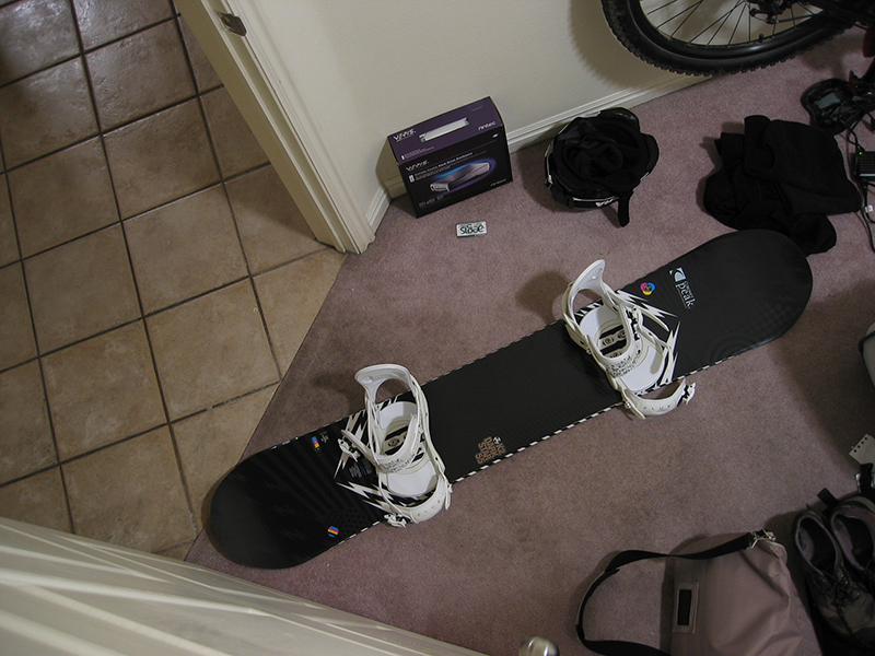A photo shot from the above shows a snowboard featuring Flux premium bindings.