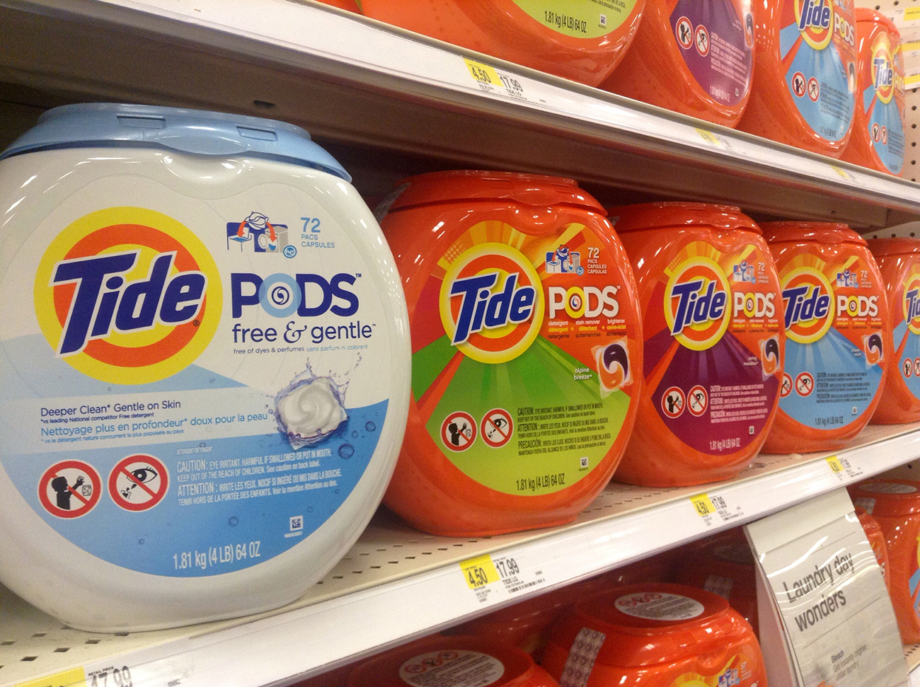 A photo shows a close-up of Tide Pods displayed on the shelves of a supermarket.