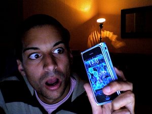 Man with a surprised face looking at his iPhone