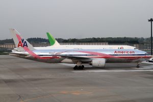 An American Airlines Boeing 747 with a pink ribbon printed along its length.