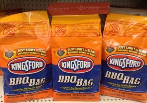 Three bags of Kingsford charcoal.