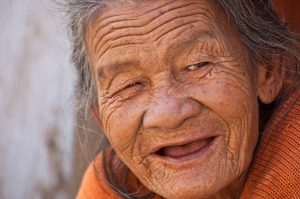 An old woman, smiling.
