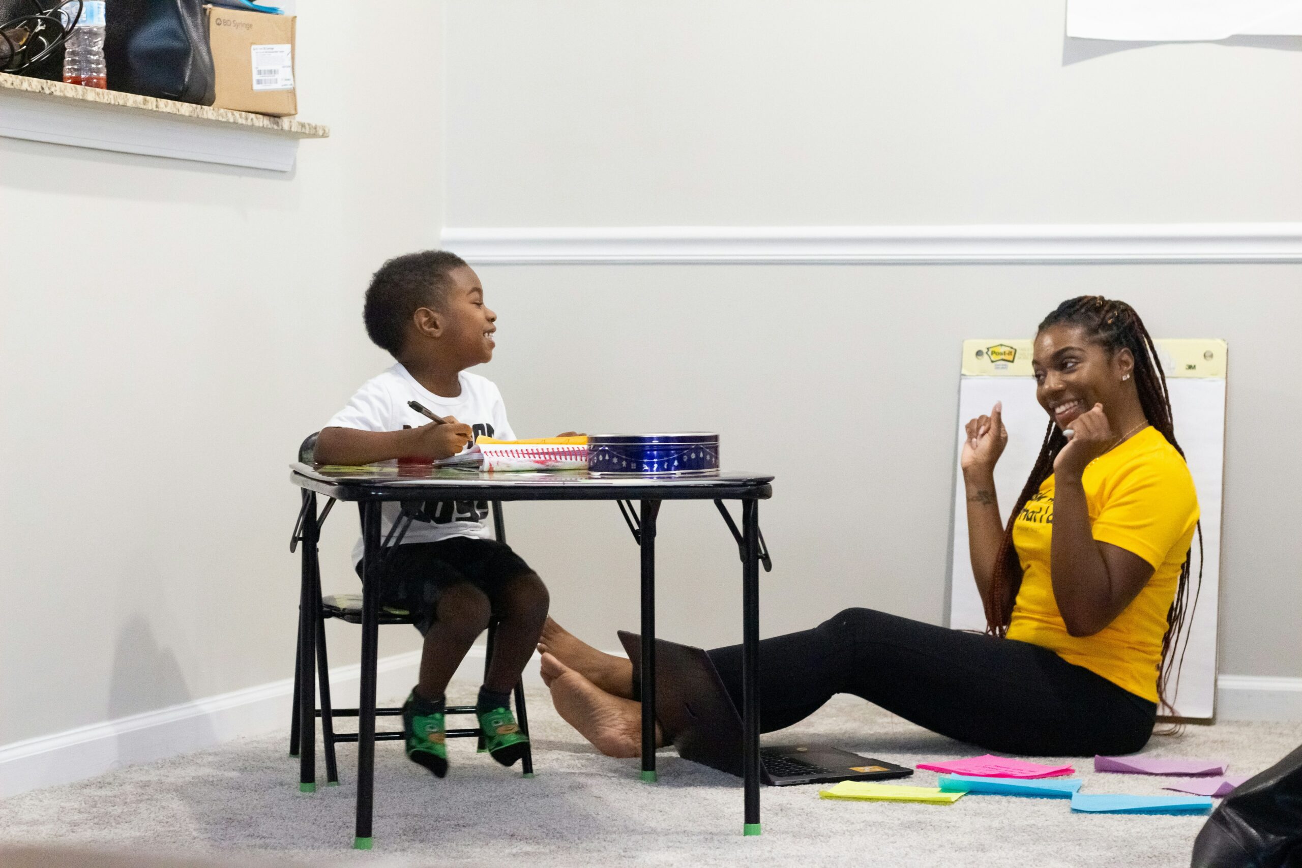 A person and a child sitting at a table.