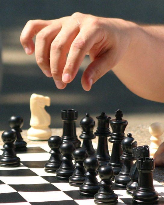 Premium Photo  A set of bright wooden chess pieces placed on a chessboard  in a brick wall background. the concept of business strategy planning. copy  space for text or article. 3d