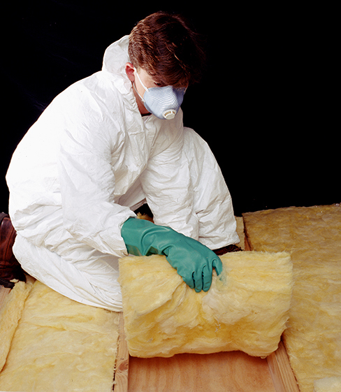 Photograph of a person handling a fiberglass batt.