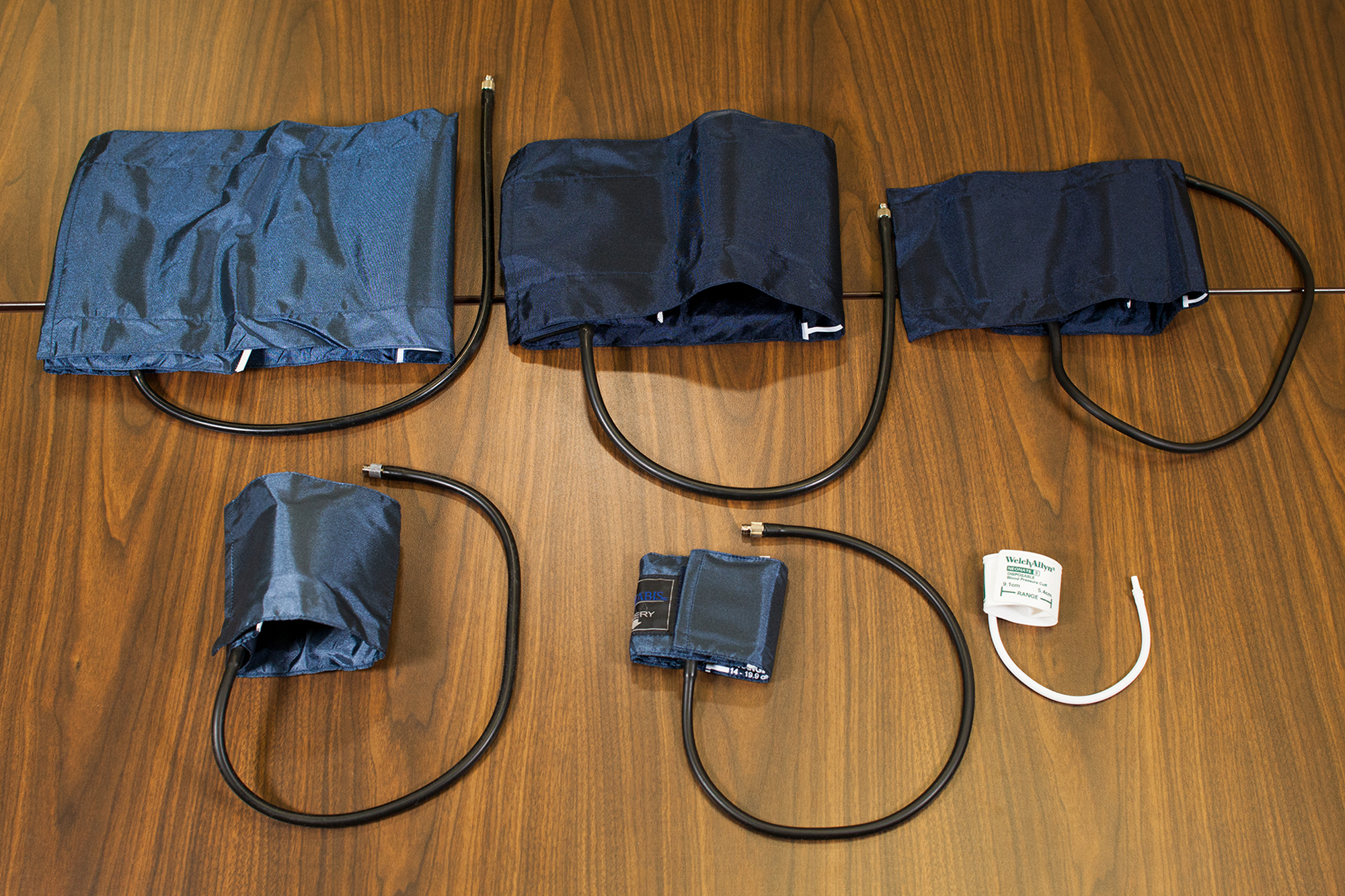Varying blood pressure cuff sizes ranging from large thigh cuffs to small neonatal cuffs