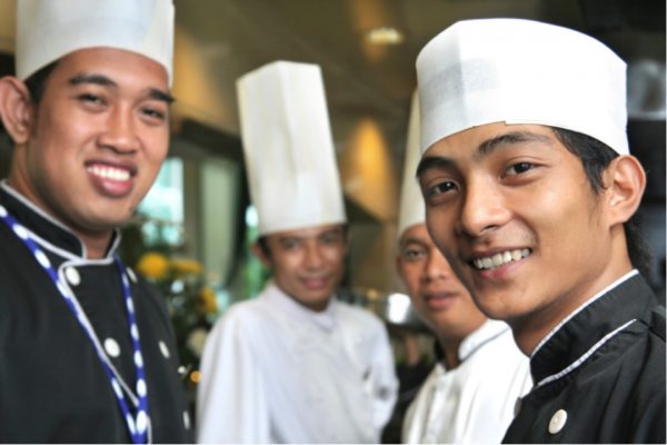 Four chefs from different regions smile for the camera.