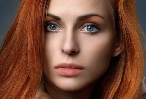 A redheaded woman with blue eyes